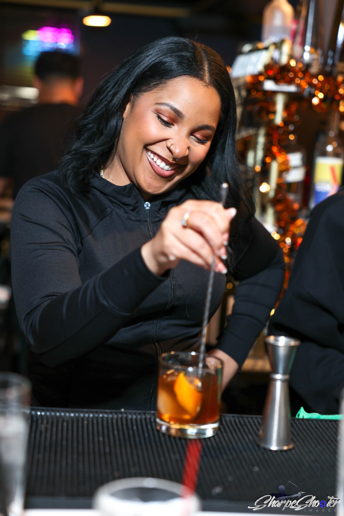Bartender stirring a cocktail behind the Deco bar